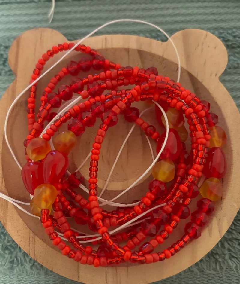 All red waist bead with red cats on there