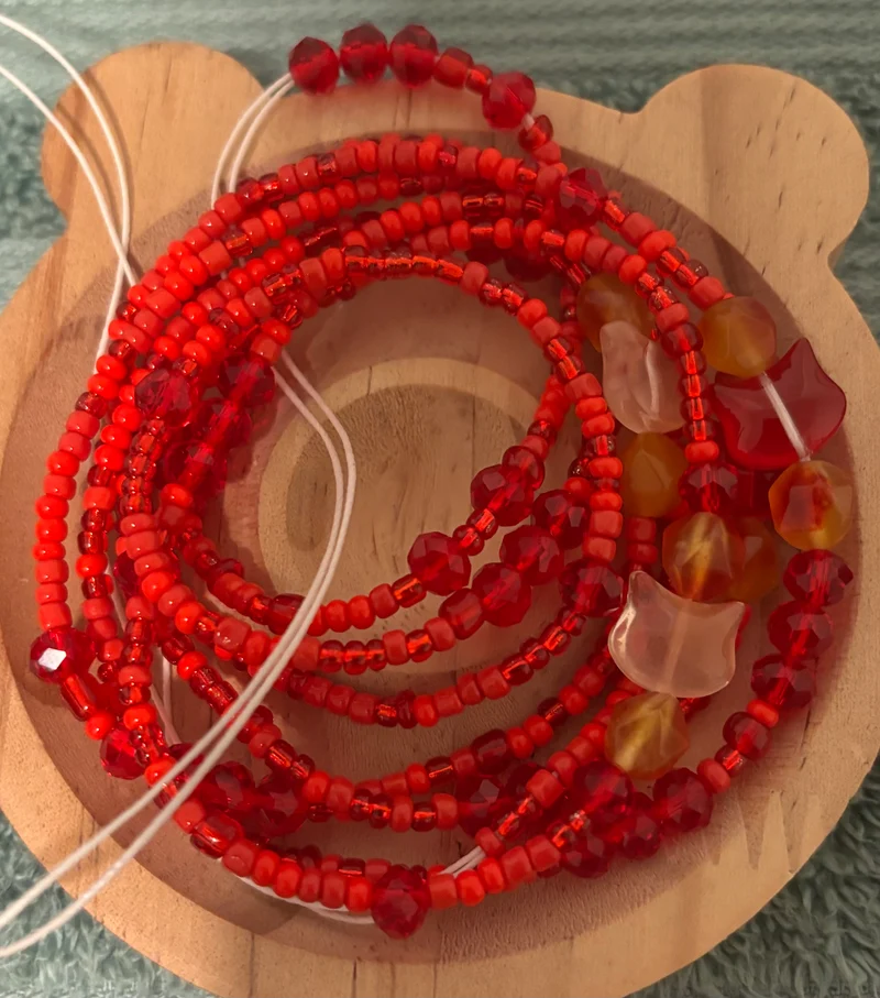 Red waist beads with cats on it