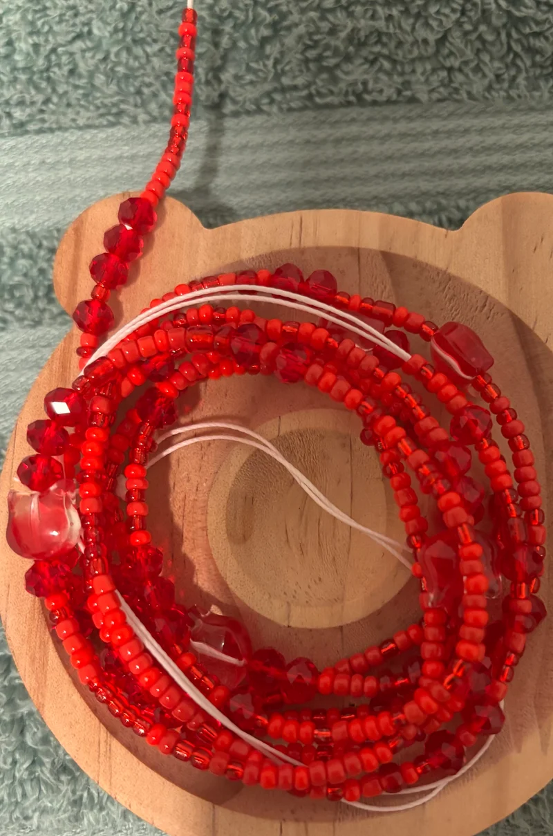 Red waist bead with cats in there