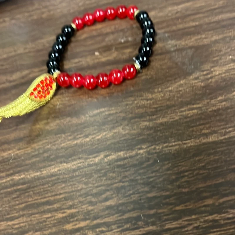 Red and black with wing charm